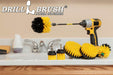 The Drillbrush 542OMS-2L-7X Medium Yellow Bathroom Brush Kit in a cordless drill sitting on a bathroom counter next to a sink and toiletries.
