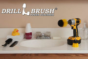 The Drillbrush MS-2L Medium Yellow Bathroom Brush Kit in a cordless drill sitting on a bathroom counter next to a sink and toiletries.