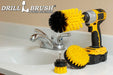 The Drillbrush 42J Medium Yellow Bathroom Brush Kit in a cordless drill sitting on a bathroom counter next to a sink.